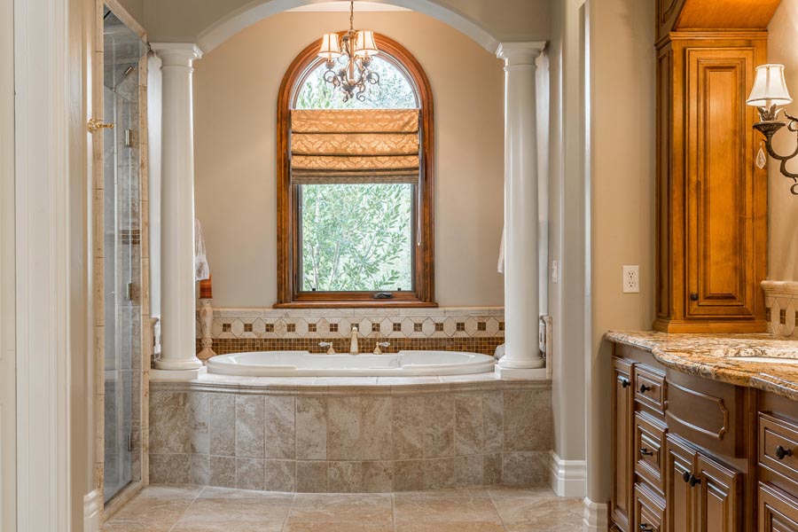 Master bathroom includes jetted tub with views of the oak trees