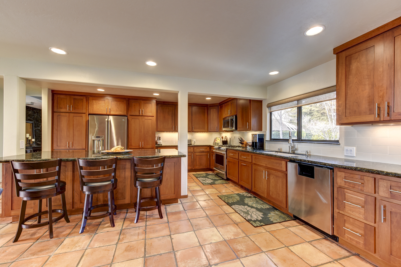 Updated cherry cabinet kitchen with stainless steel appliances